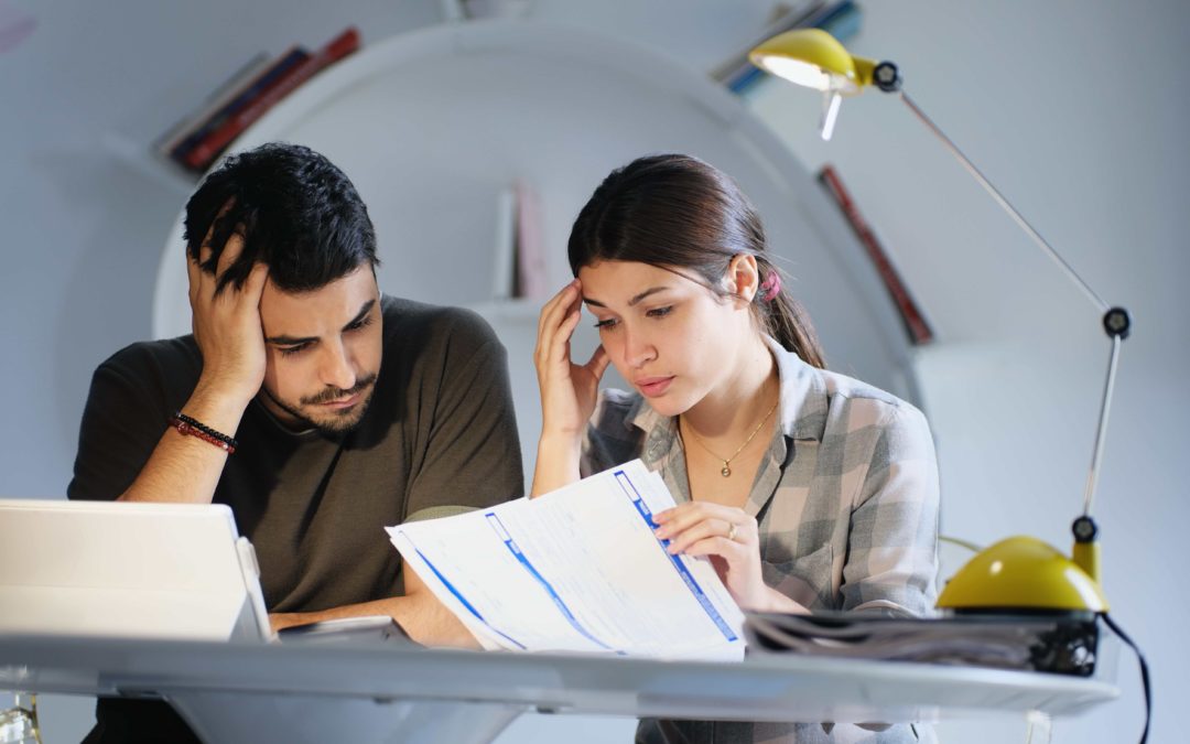 Man and Woman looking over their taxes