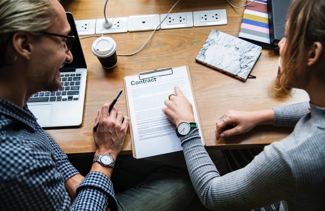 two people looking over a contract