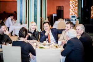 business people at dinner laughing and enjoying each other's company