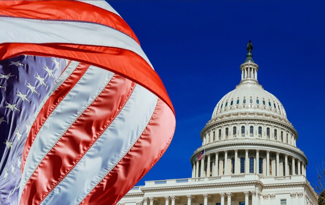 american flag in front of the US capitol Building