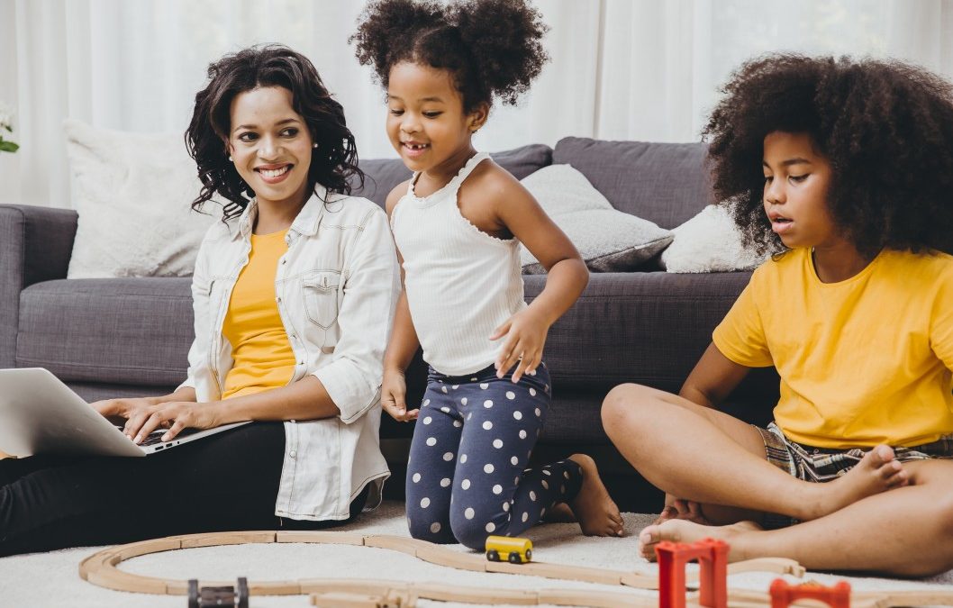 woman sitting at home with her two younger children